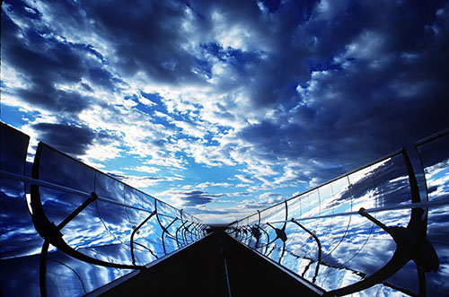 Photo of PV array and cloudy skies.